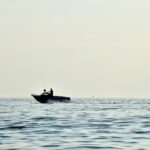 person driving speedboat on sea