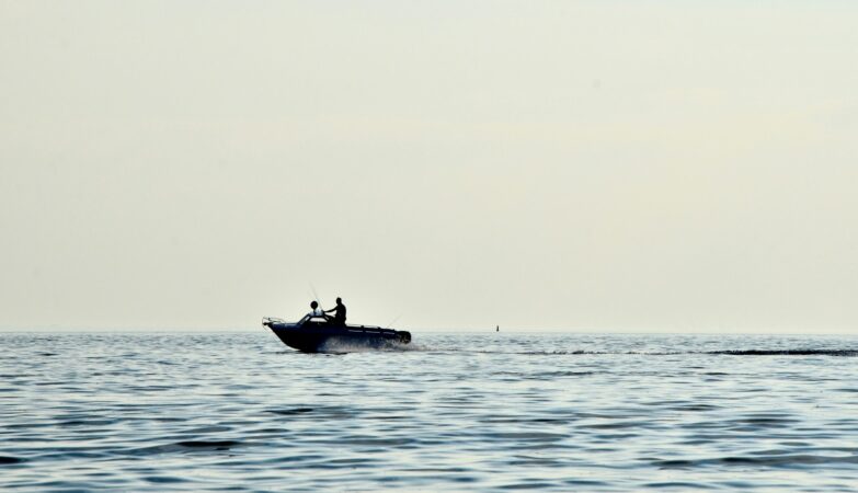 person driving speedboat on sea