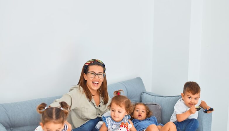 3 women sitting on gray couch